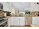 Kitchen features granite counters, stainless steel appliances, and a large sink at 107 Corte Del Rosa, Venice, FL 34285