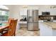 Kitchen features stainless steel appliances and granite countertop at 107 Corte Del Rosa, Venice, FL 34285
