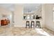 Eat-in kitchen with granite counters, stainless steel appliances, and breakfast bar at 107 Corte Del Rosa, Venice, FL 34285