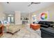 Open living area with views into the kitchen and access to the front door at 107 Corte Del Rosa, Venice, FL 34285