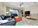 Open living room with leather sofas, a coffee table, and patio access at 107 Corte Del Rosa, Venice, FL 34285