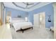 Spacious main bedroom with light blue walls and access to the patio at 107 Corte Del Rosa, Venice, FL 34285