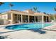 Community pool with surrounding lounge chairs at 107 Corte Del Rosa, Venice, FL 34285