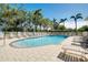 Community pool area with surrounding lounge chairs at 107 Corte Del Rosa, Venice, FL 34285