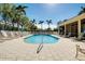 Community pool with lounge chairs and covered patio at 107 Corte Del Rosa, Venice, FL 34285