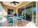 Relaxing screened porch with patio furniture and lush backyard views at 107 Corte Del Rosa, Venice, FL 34285
