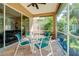 Relaxing screened porch with patio furniture and lush backyard views at 107 Corte Del Rosa, Venice, FL 34285