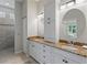 Double vanity bathroom with granite countertops, and shower at 11053 Barnsley Dr, Venice, FL 34293