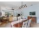 Open concept dining room with a farmhouse table and view into the living room at 11053 Barnsley Dr, Venice, FL 34293