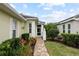 Welcoming front entry with brick walkway, landscaping, and light-colored exterior at 11053 Barnsley Dr, Venice, FL 34293