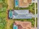 Bird's eye view of house, pool, and surrounding landscape at 12386 Sagewood Dr, Venice, FL 34293