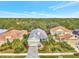 House with gray roof and light green walls, paver driveway and landscaping at 12386 Sagewood Dr, Venice, FL 34293