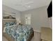 Bedroom with a queen bed, ceiling fan, and ample closet space at 12386 Sagewood Dr, Venice, FL 34293