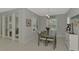 Bright dining room features a wooden table with six chairs, and access to the backyard at 12386 Sagewood Dr, Venice, FL 34293