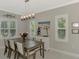 Bright dining room features a large table, chandelier, and access to the kitchen at 12386 Sagewood Dr, Venice, FL 34293