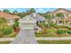Single-story home with gray roof, light green walls, and a paver driveway at 12386 Sagewood Dr, Venice, FL 34293