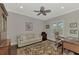 Bright home office features a comfortable couch and a large desk at 12386 Sagewood Dr, Venice, FL 34293