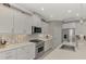 Modern kitchen with white cabinets, quartz countertops and stainless steel appliances at 12386 Sagewood Dr, Venice, FL 34293