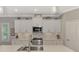 Bright kitchen features white cabinets, stainless steel appliances, and a quartz countertop at 12386 Sagewood Dr, Venice, FL 34293