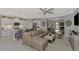 Open concept kitchen boasts white cabinets, stainless steel appliances, and an island at 12386 Sagewood Dr, Venice, FL 34293