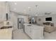 Open concept kitchen features a large island, stainless steel appliances, and white cabinets at 12386 Sagewood Dr, Venice, FL 34293