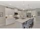 Modern kitchen with white cabinets, quartz countertops, and a large island at 12386 Sagewood Dr, Venice, FL 34293
