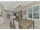 Open concept kitchen and dining area with stainless steel appliances and an island at 12386 Sagewood Dr, Venice, FL 34293