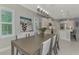 View of kitchen and dining area with white cabinets and spacious layout at 12386 Sagewood Dr, Venice, FL 34293