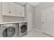Laundry room with washer, dryer, and ample cabinet storage at 12386 Sagewood Dr, Venice, FL 34293
