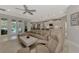 Open living room with seating and views to kitchen and pool at 12386 Sagewood Dr, Venice, FL 34293