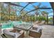 Inviting pool area with a covered patio and lounge chairs at 12386 Sagewood Dr, Venice, FL 34293