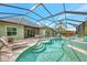 Inviting pool and spa with screened enclosure, perfect for relaxation at 12386 Sagewood Dr, Venice, FL 34293