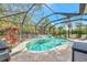Resort style pool with a screened enclosure and outdoor kitchen at 12386 Sagewood Dr, Venice, FL 34293