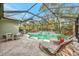 Spacious pool area with a screened enclosure and plenty of seating at 12386 Sagewood Dr, Venice, FL 34293