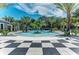 Stunning pool with palm trees and a checkerboard patio at 12386 Sagewood Dr, Venice, FL 34293