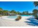 Community pool with shaded seating and lush landscaping at 12386 Sagewood Dr, Venice, FL 34293