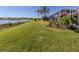 Spacious backyard with screened enclosure, overlooking a lake at 1374 Brenner Park Dr, Venice, FL 34292