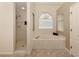 Bathroom featuring a garden tub, walk-in shower, and a large window at 1374 Brenner Park Dr, Venice, FL 34292