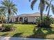 Single story home with tile roof and landscaped yard at 1374 Brenner Park Dr, Venice, FL 34292