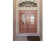 Double front doors with arched window and glass inserts at 1374 Brenner Park Dr, Venice, FL 34292