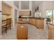 Large kitchen featuring an island, granite countertops, and built-in desk area at 1374 Brenner Park Dr, Venice, FL 34292