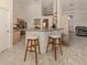 Kitchen with breakfast bar, granite countertops and beige cabinetry at 1374 Brenner Park Dr, Venice, FL 34292