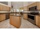 Spacious kitchen with island, stainless steel appliances, and granite countertops at 1374 Brenner Park Dr, Venice, FL 34292