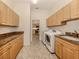 Laundry room with granite counters, washer, dryer, and access to kitchen at 1374 Brenner Park Dr, Venice, FL 34292