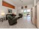 Bright and airy living room with sliding doors to lanai at 1374 Brenner Park Dr, Venice, FL 34292