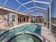 Refreshing pool and spa with screened enclosure and solar panels at 1374 Brenner Park Dr, Venice, FL 34292