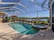 Inviting screened-in pool and spa with lake view at 1374 Brenner Park Dr, Venice, FL 34292