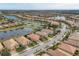 Community overview showcasing homes and a central lake at 13836 Karina St, Venice, FL 34293