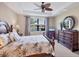 Bright bedroom featuring a king-size bed and dresser at 13836 Karina St, Venice, FL 34293