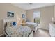 Twin bedroom with two beds and decorative wall art at 13836 Karina St, Venice, FL 34293